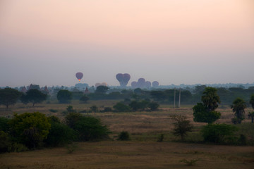 Beautiful landscape view sunrise of pagoda with balloons in Bagan city, Myanmar. A romantic great place for travel.
