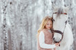 Little blonde girl with a white horse