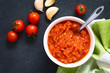 Homemade traditional Italian marinara or pomodoro tomato sauce made of fresh tomato, garlic, dried oregano and salt, photographed overhead with natural light (Selective Focus on the sauce)