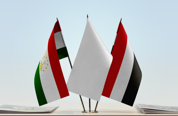 Flags of Tajikistan and Yemen with a white flag in the middle