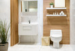 canvas print picture - Modern spacious bathroom with bright tiles with toilet and sink. Side view