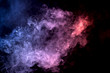 © Виталий Сова - Cloud of smoke of purple, red and blue colors on black  isolated background. Background from the smoke of vape