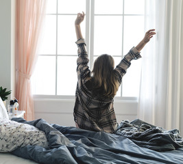 Wall Mural - rear view of woman stretching her arms in the morning