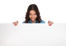 Smiling Casual Woman Standing Above A Big Blank Board