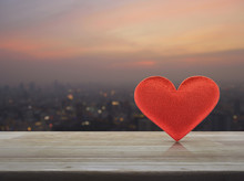 Fabric Red Love Heart Shape On Wooden Table Over Blur Of Cityscape On Warm Light Sundown, Valentines Day Concept
