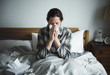© Rawpixel.com - A woman suffering from flu in bed