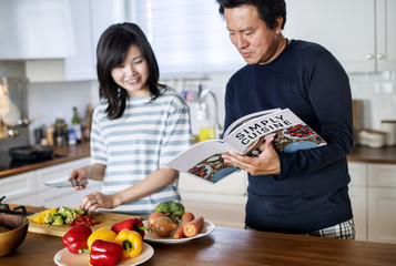 Canvas Print - Asian couple cooking in the kitchen