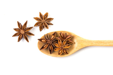 Wall Mural - Close up the brown star anise spice in wooden spoon isolated on white background