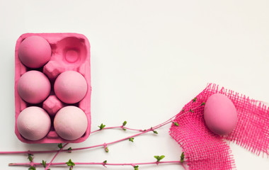 Wall Mural - Pink easter eggs in pink box, on white table, decorated with pink branches; easter background