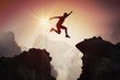 canvas print picture - Silhouette of young man jumping over mountains and cliffs at sunset.