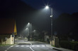 empty night street on small village with modern street lights