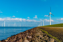 Offshore Windmill Farm In The Ocean  Westermeerwind Park , Windmills Isolated At Sea On A Beautiful Bright Day Netherlands Flevoland Noordoostpolder