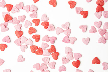 close-up view of red and pink sugar hearts forming an abstract background pattern.