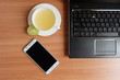 © damrong - Top view, freshly Lime juice in a white cup, mobile phone and laptop on wooden floor
