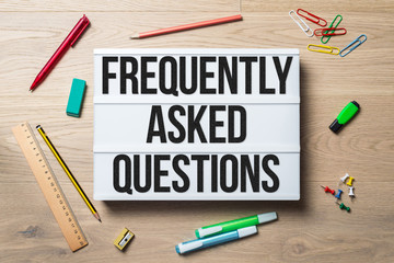 Wall Mural - frequently asked questions written on lightbox lying on floor
