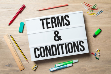 Wall Mural - terms and conditions written on lightbox in office as flatlay
