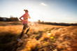 © lightpoet - Young woman running outdoors on a lovely sunny winter/fall day (motion blurred image)