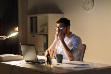 Sticker - tired businessman with laptop at night office