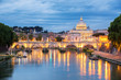 Sunset view of St. Peters Basilica in the Vatican and the Ponte Sant'Angelo, Bridge of Angels, at the Castel Sant'Angelo and river Tiber in Rome, Italy