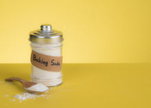 Jar Of Baking Soda With Text Space Against Yellow Background