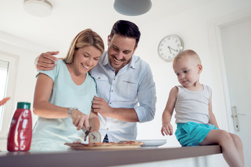 Sticker - Father,mother and son eating a big pizza.