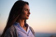© blvdone - Young Indian woman looking up sunset sky