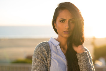 Wall Mural - Young Indian woman serious face sunset