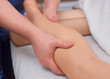 The doctor-podiatrist does an examination and massage of the patient's legs