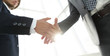 © ASDF - Two  business men going to make handshake