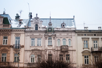 Colored facades of the architectural old houses in the city center of Lviv, Ukraine. Blue winter sky on the background.