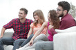 © ASDF - group of cheerful friends sitting on the couch