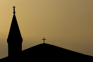 View of mosque and church against sky during sunset