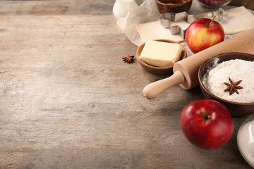 Wall Mural - Composition with raw puff pastry and ingredients on wooden background