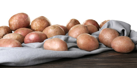 Sticker - Fresh raw potatoes on wooden table against white background