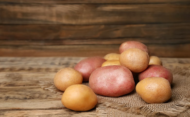 Sticker - Fresh raw potatoes on wooden table