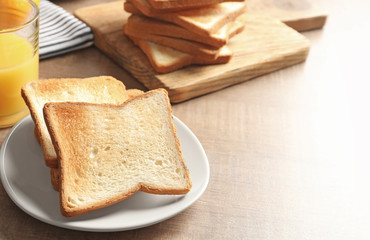 Sticker - Plate with tasty toasted bread on wooden table