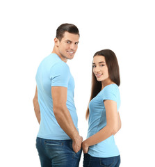 Wall Mural - Young man and woman in stylish t-shirts on white background. Mockup for design