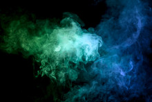 Thick Colorful Smoke Of  Blue And Green On A Black Isolated Background. Background From The Smoke Of Vape