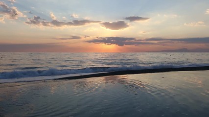 Canvas Print - Beautiful tropical sunset on the sea wavy beach.  Picturesque sky reflection in water puddle, mountain in far, and birds in sky. Calabria, Italy, Tyrrhenian sea.