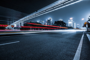 Wall Mural - the light trails on the modern building background.