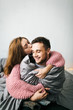 © stakhov - Cute Young Woman Embracing and Kiss Her Boyfriend. A couple having fun in the bed. Artwork. Soft focus