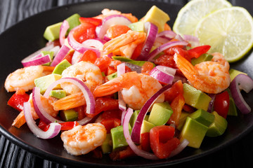 Wall Mural - Latin American ceviche seafood with vegetables and lime close up on a plate on the table. horizontal