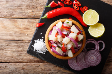 Wall Mural - Traditional ceviche seafood with vegetables and lime close up on a plate. horizontal top view