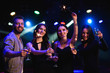 © nagaets - Dynamic young friends dancing at disco party