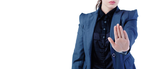 Middle section of young businesswoman making stop sign on white background, focus on a palm.