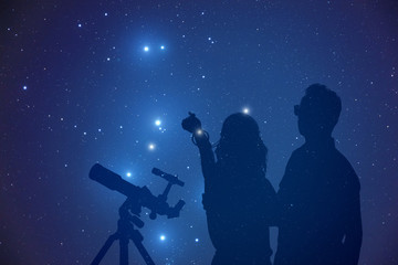 Young couple enjoying under the Milky Way stars. 