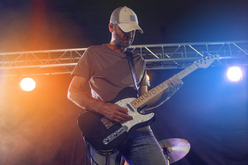 Wall Mural - The guitarist performs on stage.