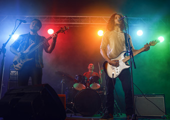 Wall Mural - Rock band performs on stage.