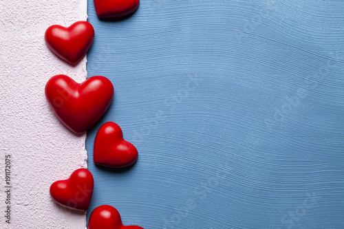 Fotomural Red hearts on blue and pink plastered background