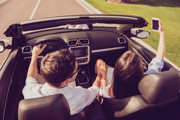 Married brunet family, relax escape, tourism destination, speed ride drive lifestyle. Carefree driver husband, lady wife with camera take shot, make memories of honeymoon road trip, hold arms